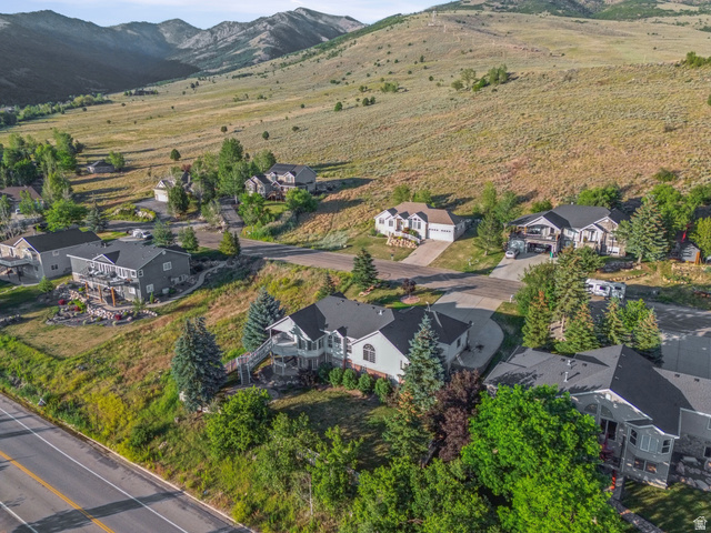 4117 North Wolf Ridge Circle Eden, UT 84310 - Photo 63 of 63 Residential properties nestled into a sloping hillside, featuring diverse architectural styles and mature landscaping