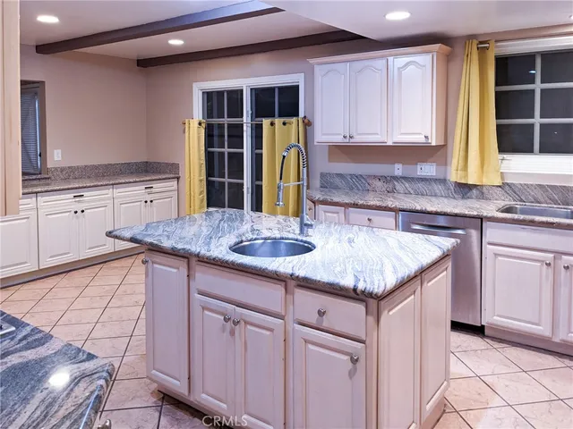 a kitchen with stainless steel appliances granite countertop a sink and cabinets