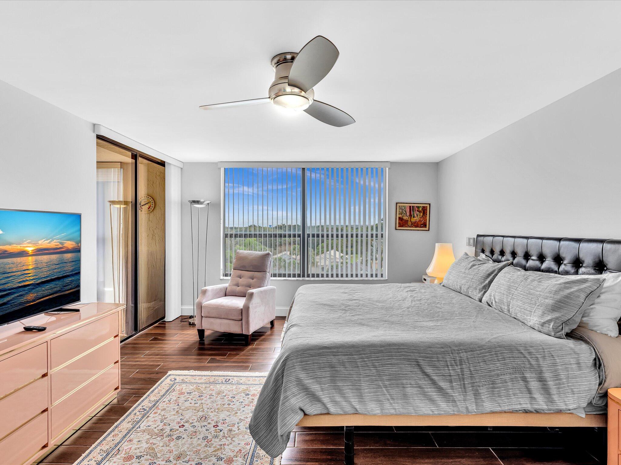 7201 Promenade Drive, Unit 602 Boca Raton, FL 33433 - Photo 11 of 77 a bedroom with a bed and a flat screen tv