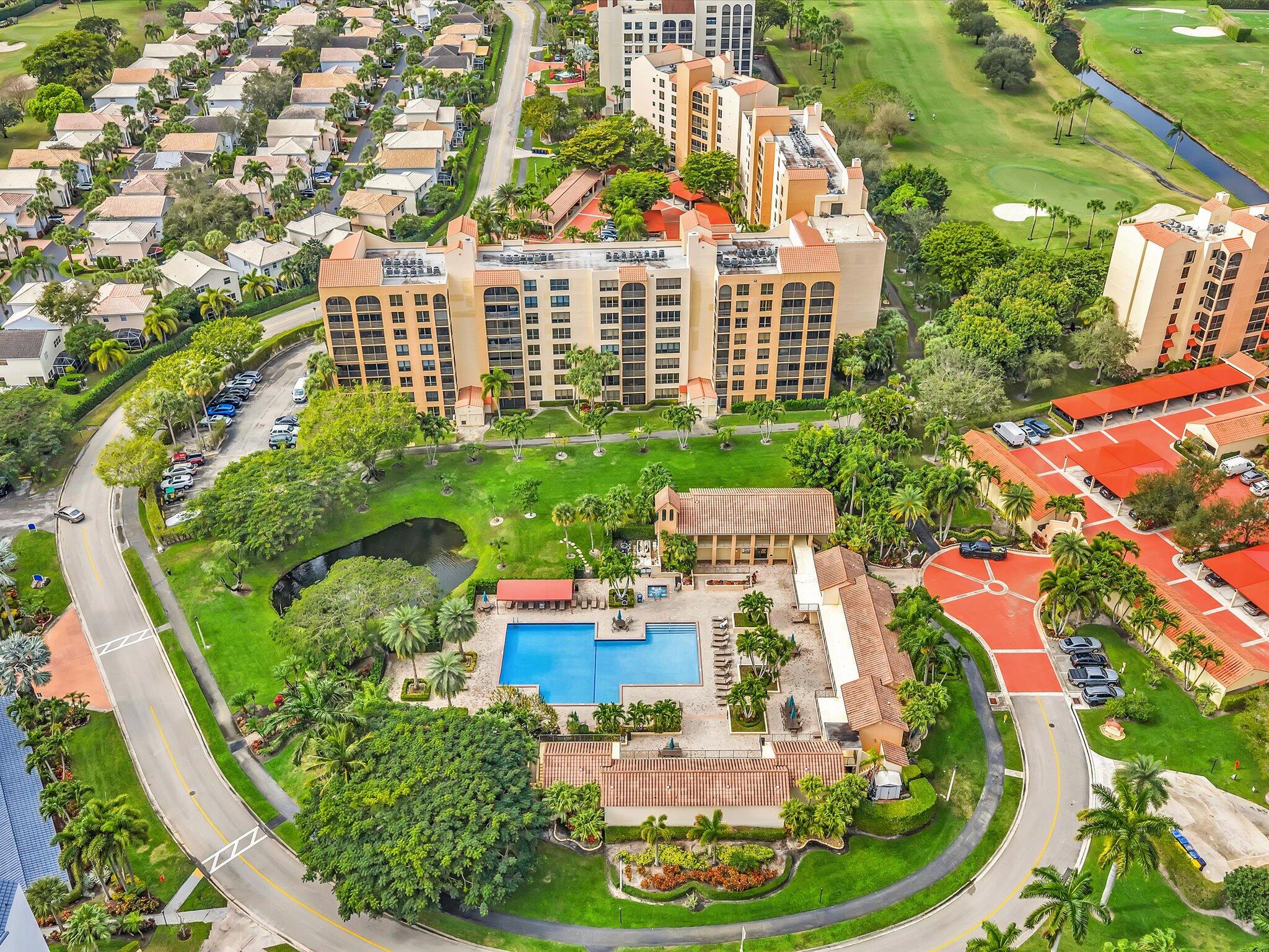 7201 Promenade Drive, Unit 602 Boca Raton, FL 33433 - Photo 15 of 77 a view of a multi story residential apartment building with a yard