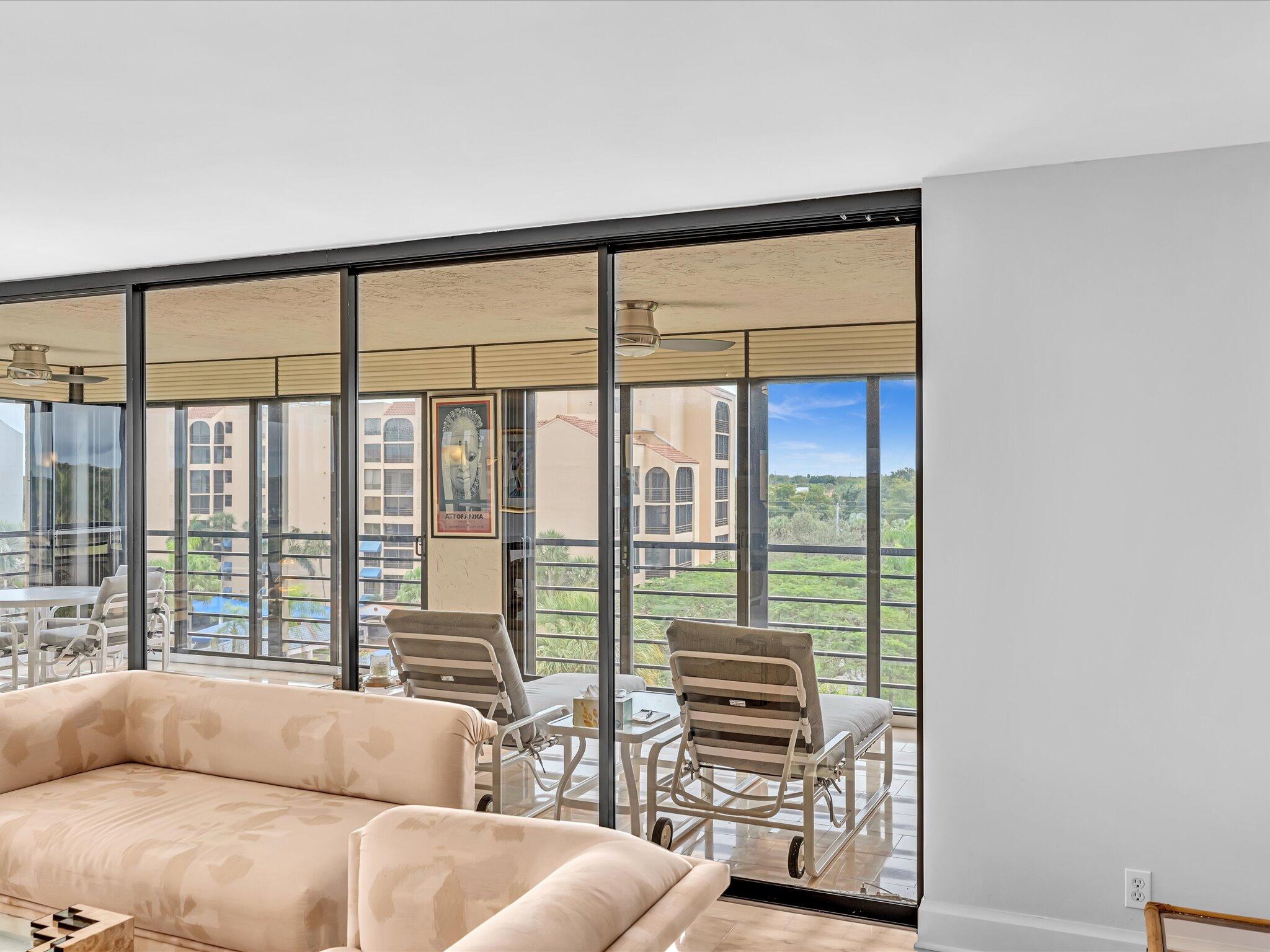 7201 Promenade Drive, Unit 602 Boca Raton, FL 33433 - Photo 29 of 77 a living room with furniture and a floor to ceiling window
