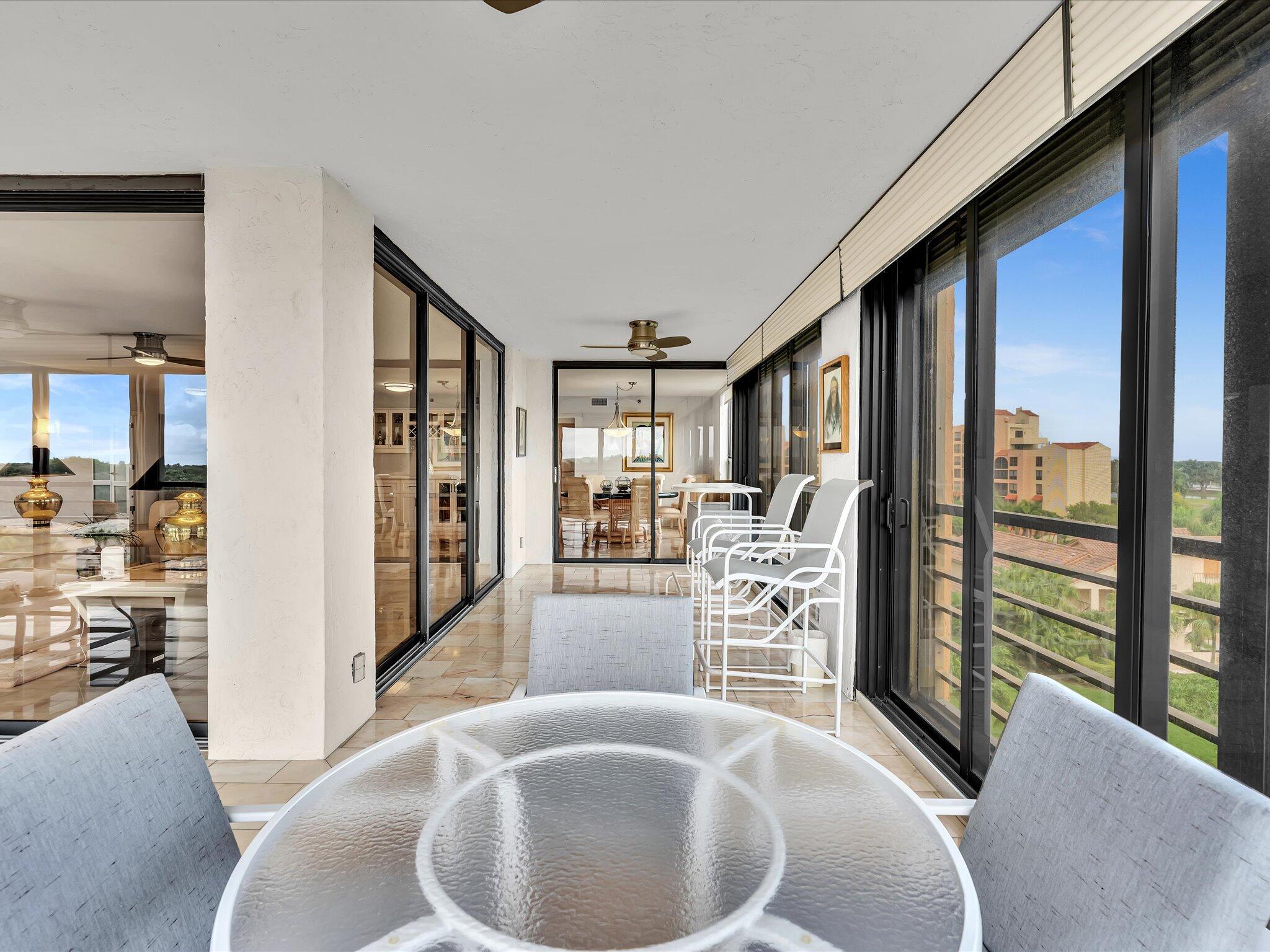 7201 Promenade Drive, Unit 602 Boca Raton, FL 33433 - Photo 32 of 77 a dining room with furniture and a large window