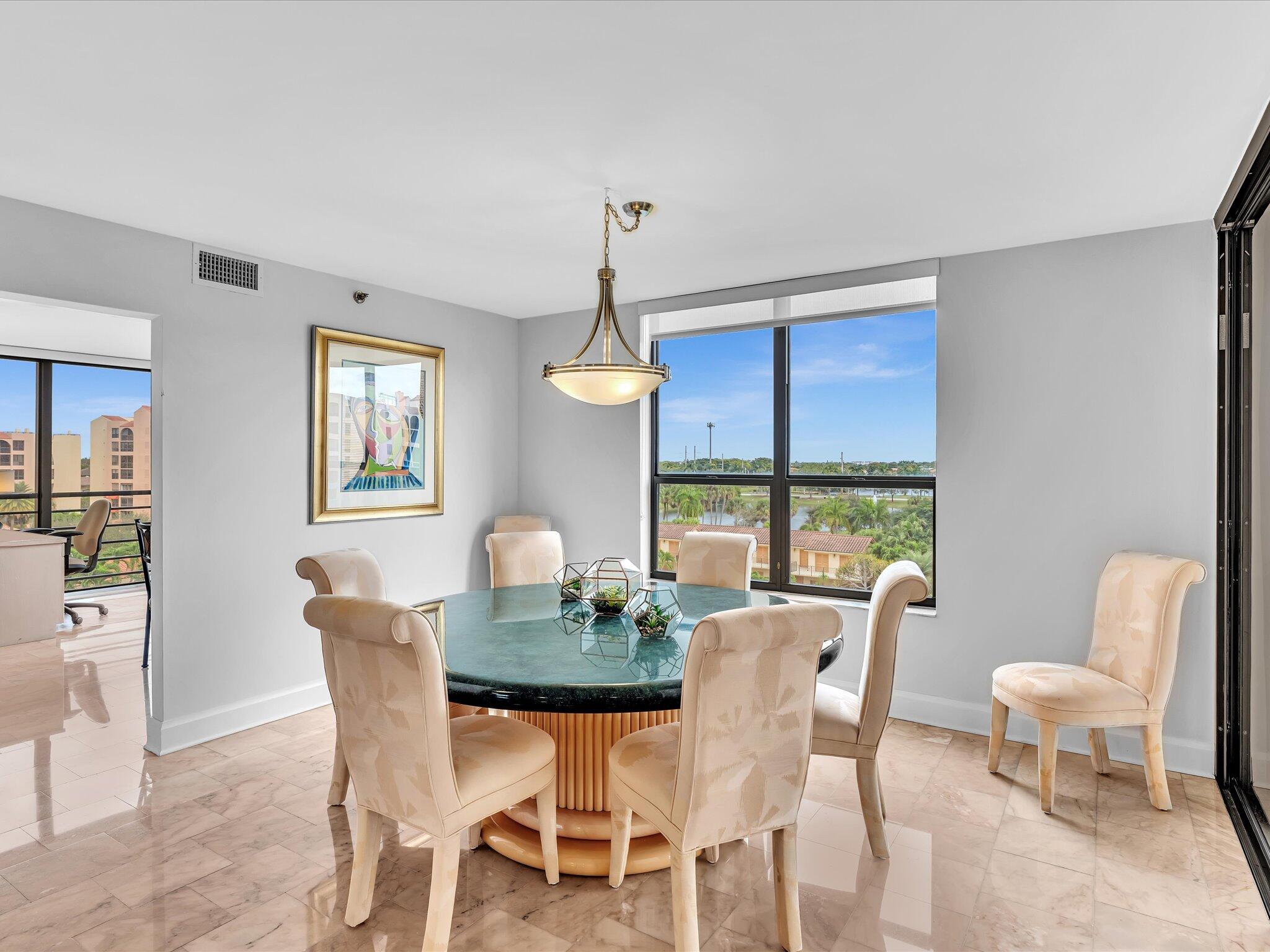 7201 Promenade Drive, Unit 602 Boca Raton, FL 33433 - Photo 35 of 77 a dining room with furniture a chandelier and window
