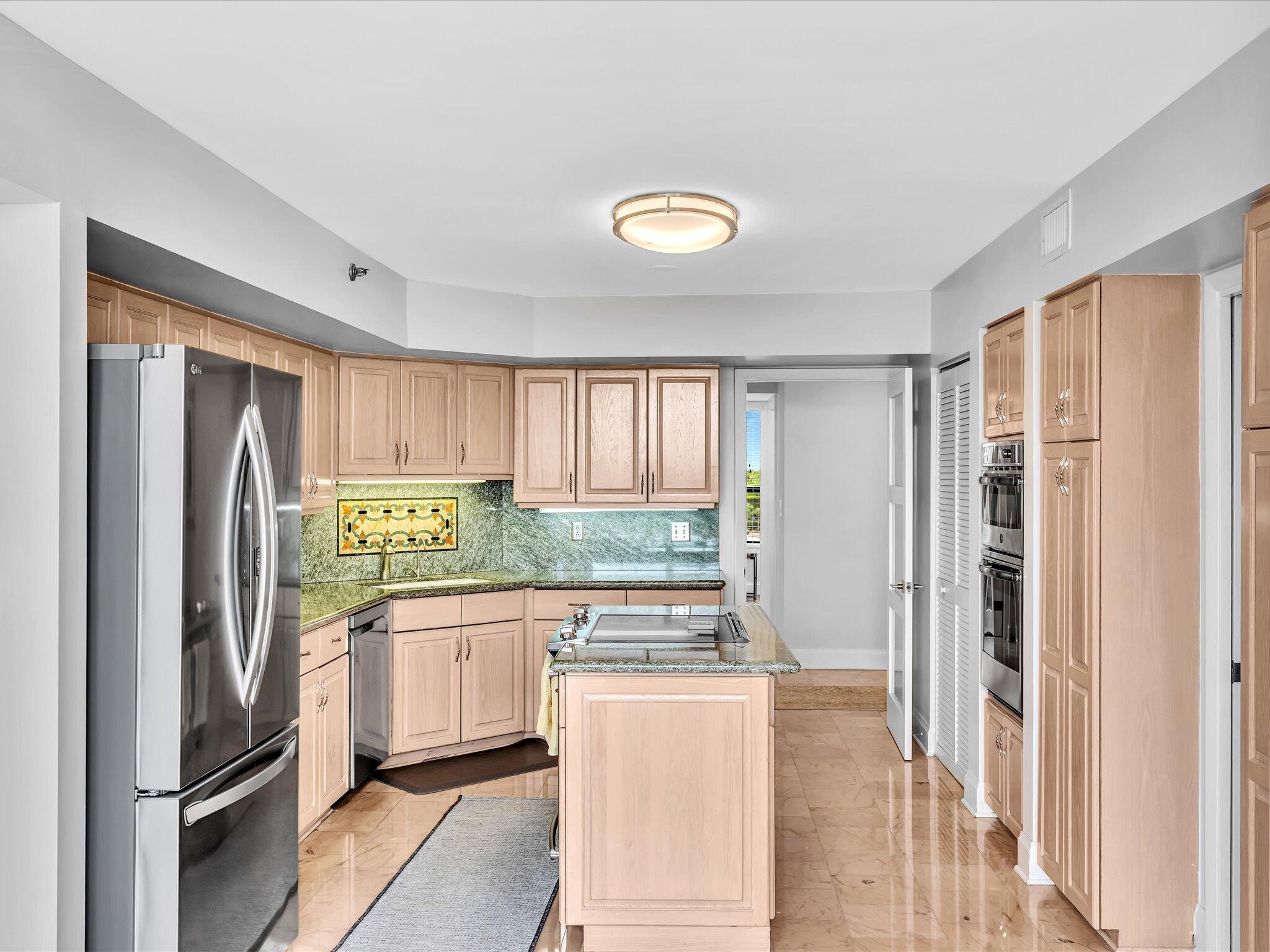 7201 Promenade Drive, Unit 602 Boca Raton, FL 33433 - Photo 39 of 77 a kitchen with stainless steel appliances granite countertop a refrigerator and a stove