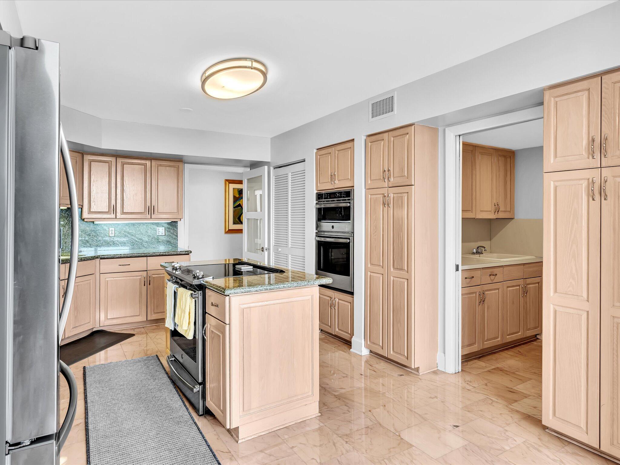 7201 Promenade Drive, Unit 602 Boca Raton, FL 33433 - Photo 40 of 77 a kitchen with a stove and a refrigerator