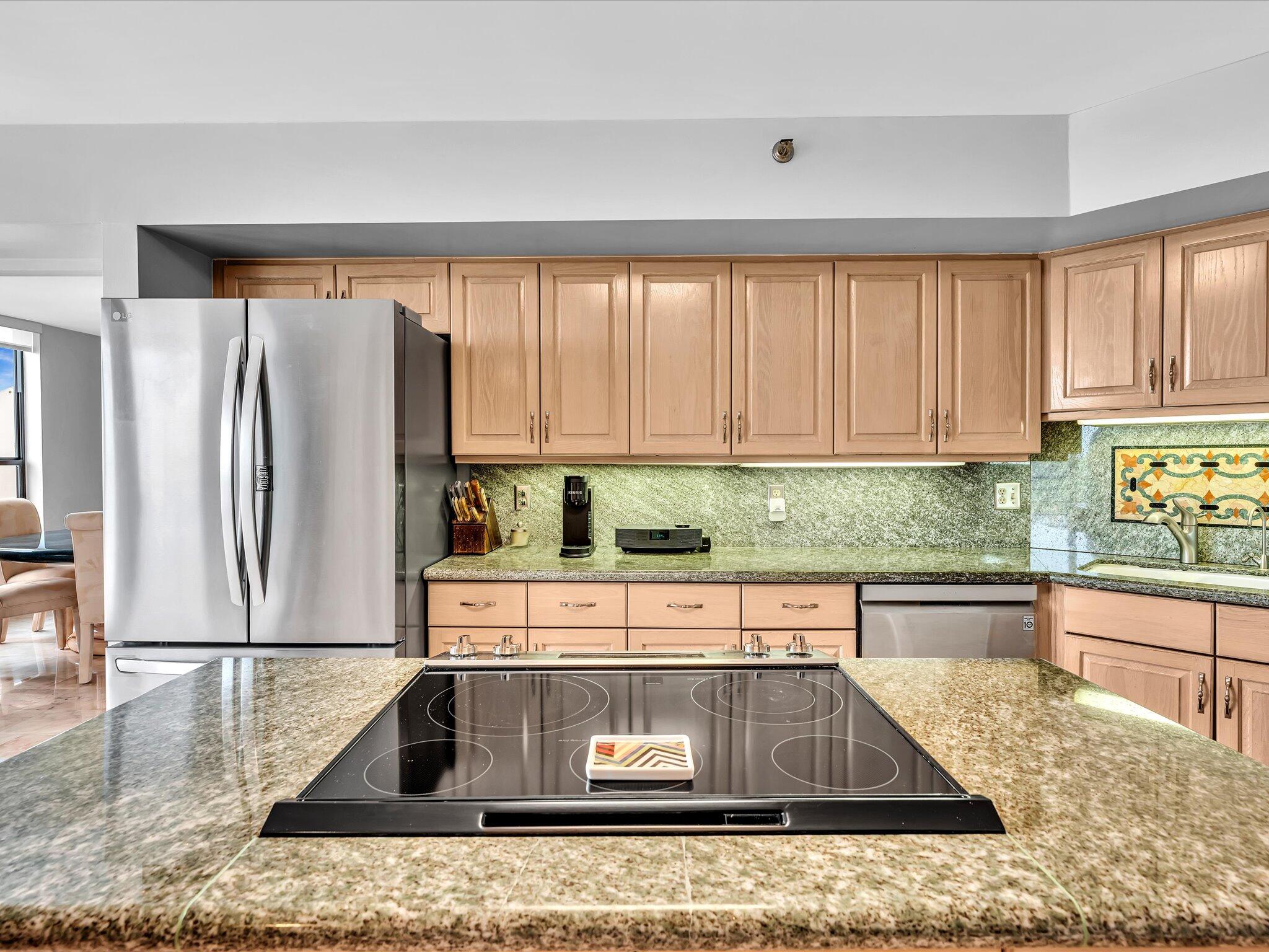 7201 Promenade Drive, Unit 602 Boca Raton, FL 33433 - Photo 44 of 77 a kitchen with stainless steel appliances granite countertop a sink and a counter space