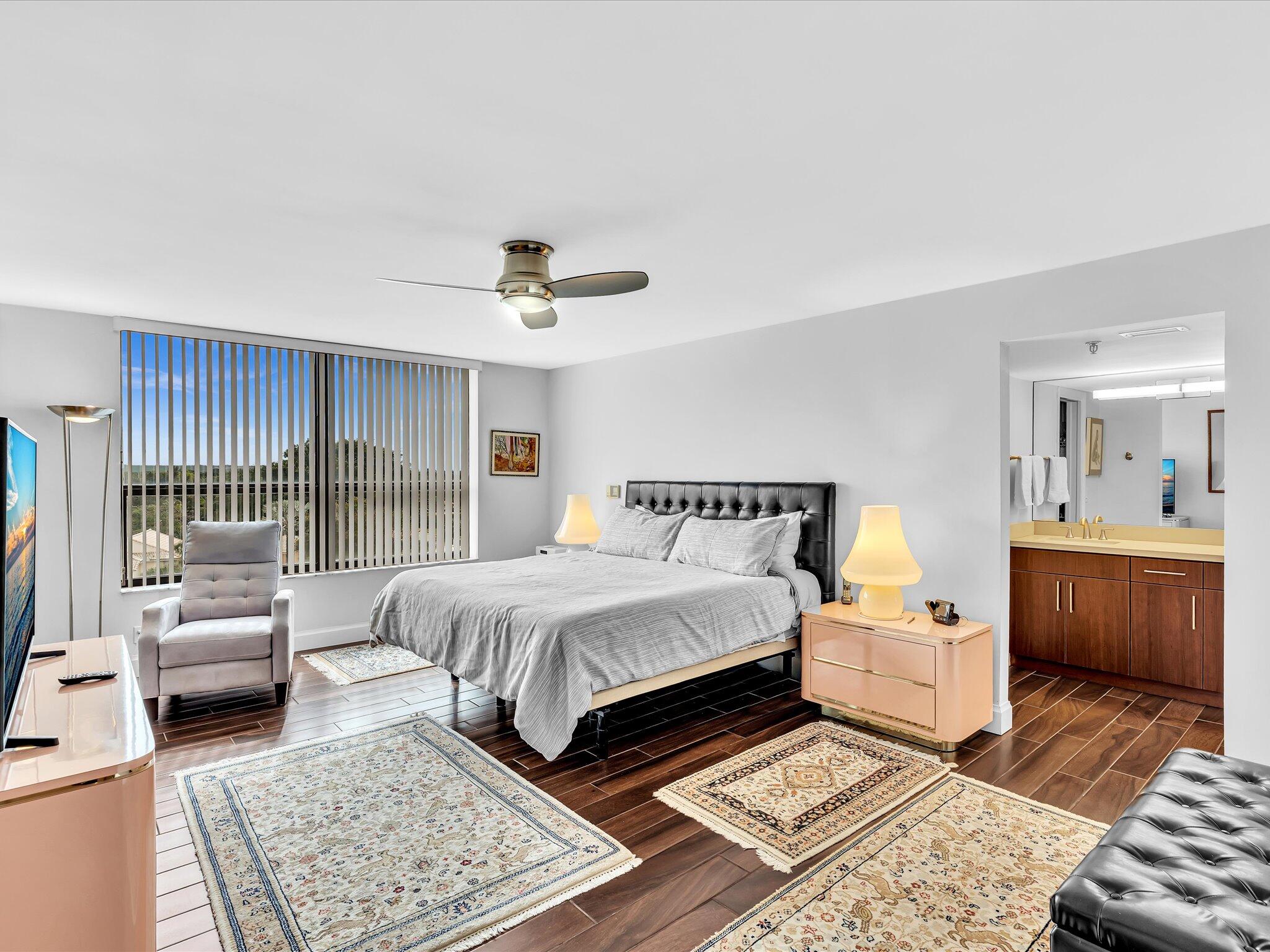 7201 Promenade Drive, Unit 602 Boca Raton, FL 33433 - Photo 49 of 77 a spacious bedroom with a bed and a couch