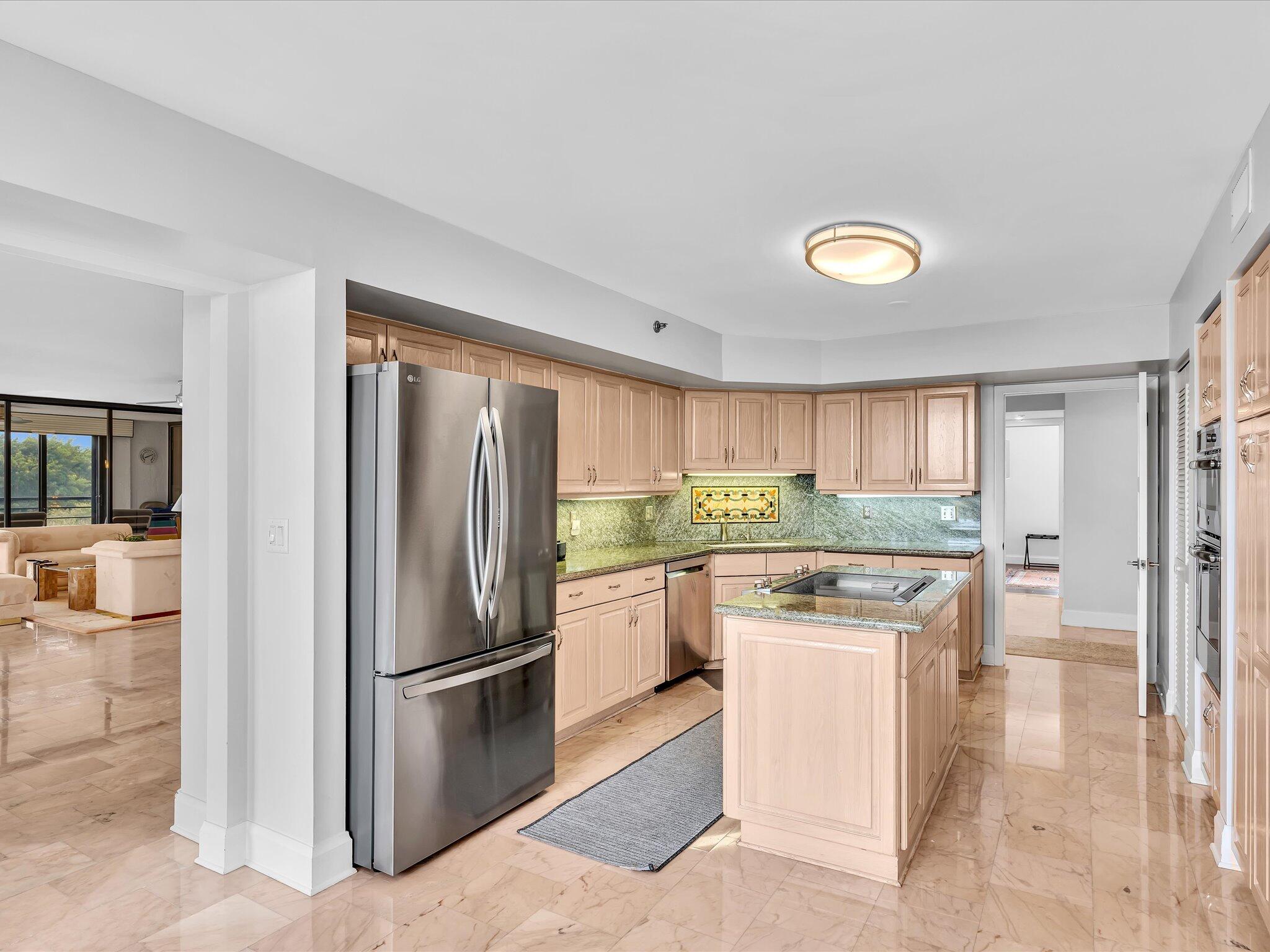 7201 Promenade Drive, Unit 602 Boca Raton, FL 33433 - Photo 9 of 77 a kitchen with stainless steel appliances granite countertop a refrigerator a stove and a sink with cabinets
