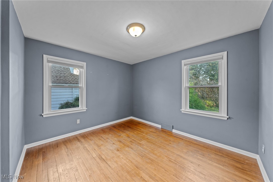6315 Brookside Road Independence, OH 44131 - Photo 15 of 41 Empty room featuring baseboards, hardwood / wood-style flooring, and visible vents