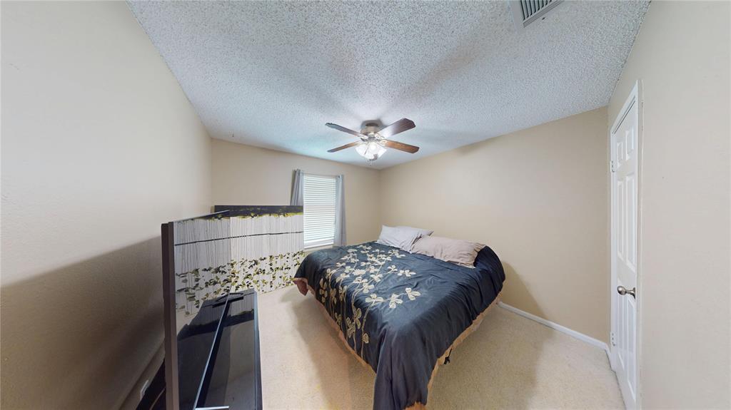 1317 Colonial Place Flower Mound, TX 75028 - Photo 14 of 20 Room featuring a ceiling fan with light fixture, textured ceiling, light-colored walls, and a window with blinds