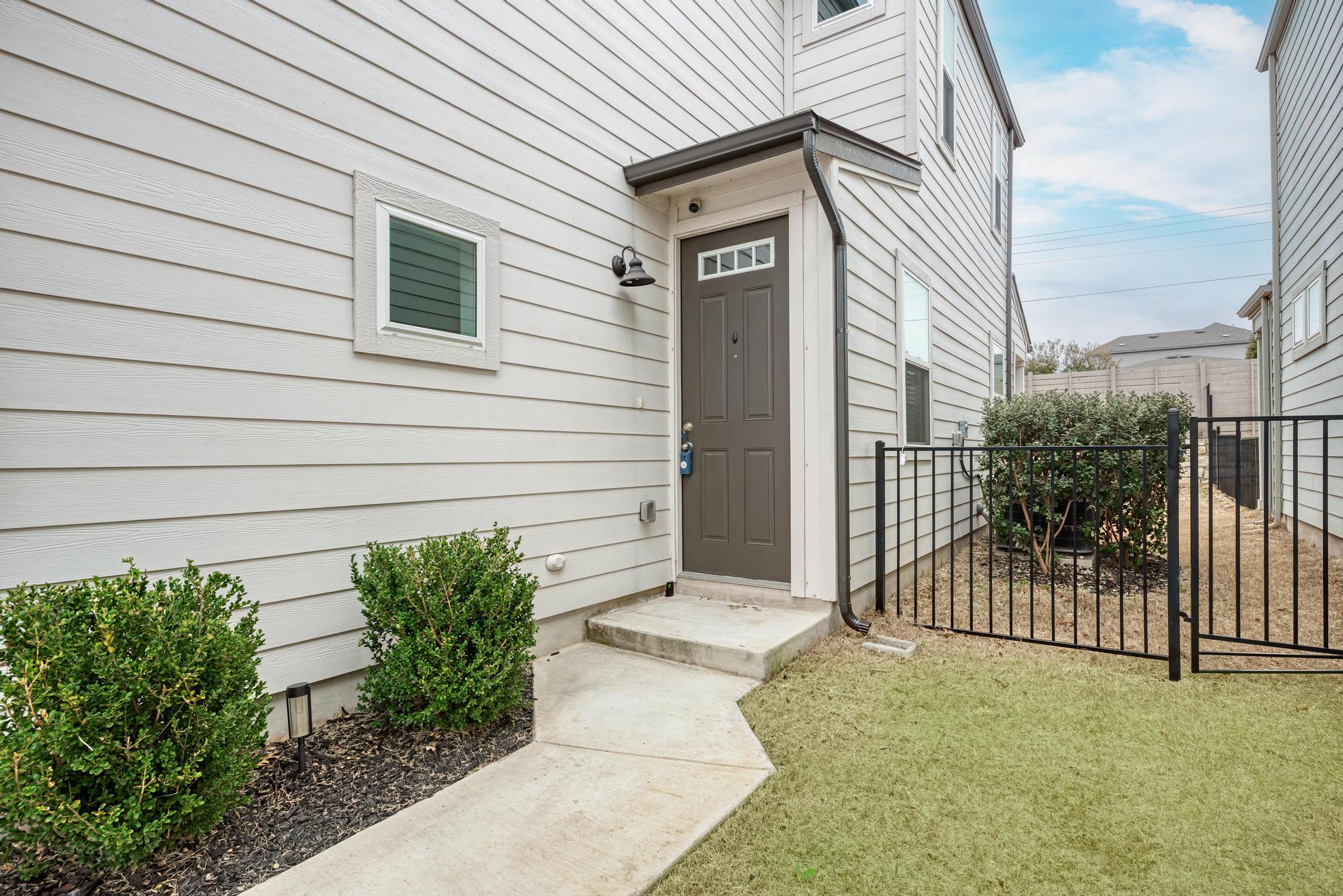 7319 Travertine Spring Drive, Unit 115 Austin, TX 78744 - Photo 11 of 37 a house view with a backyard space