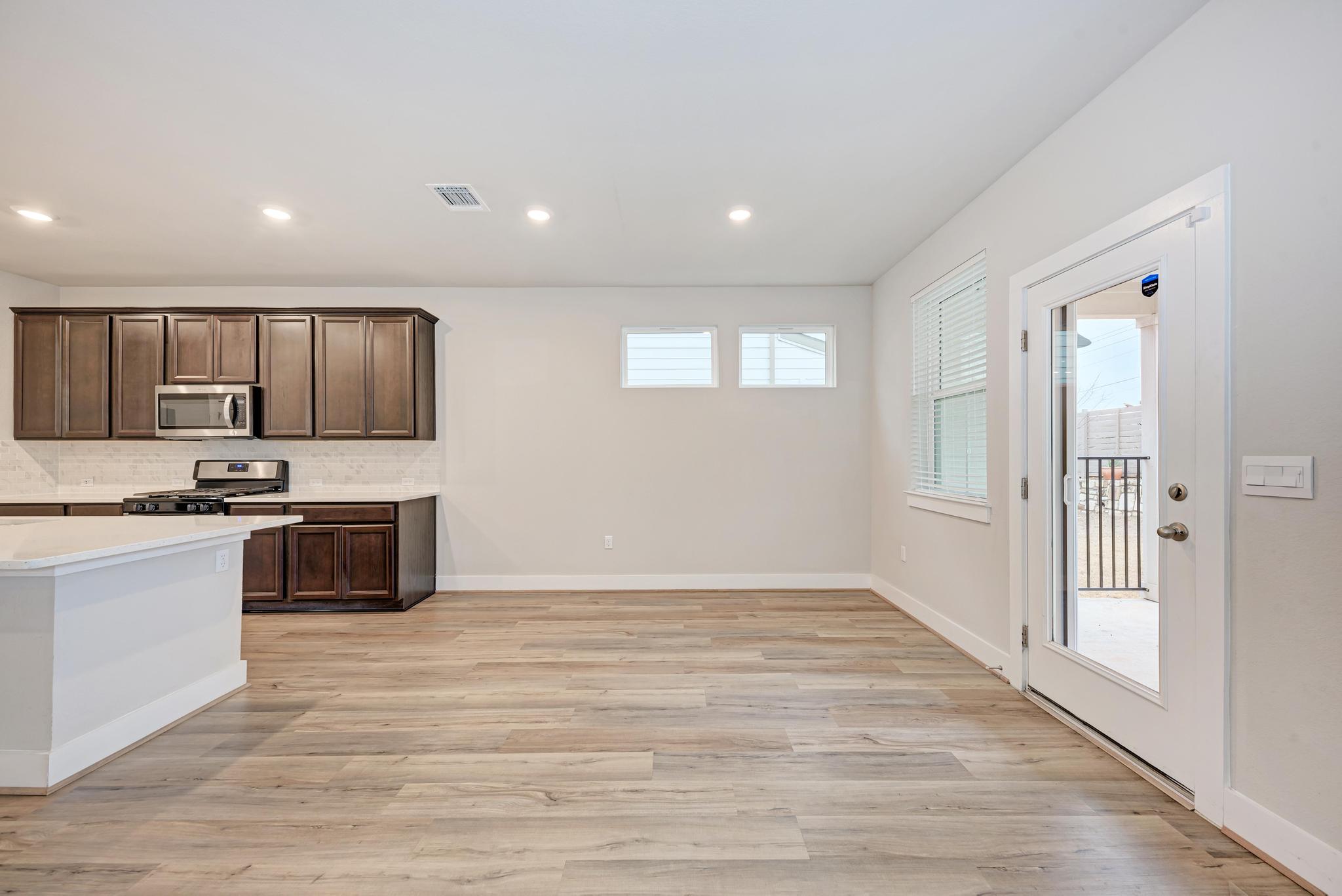 7319 Travertine Spring Drive, Unit 115 Austin, TX 78744 - Photo 16 of 37 a kitchen with stainless steel appliances granite countertop a stove a sink and a refrigerator