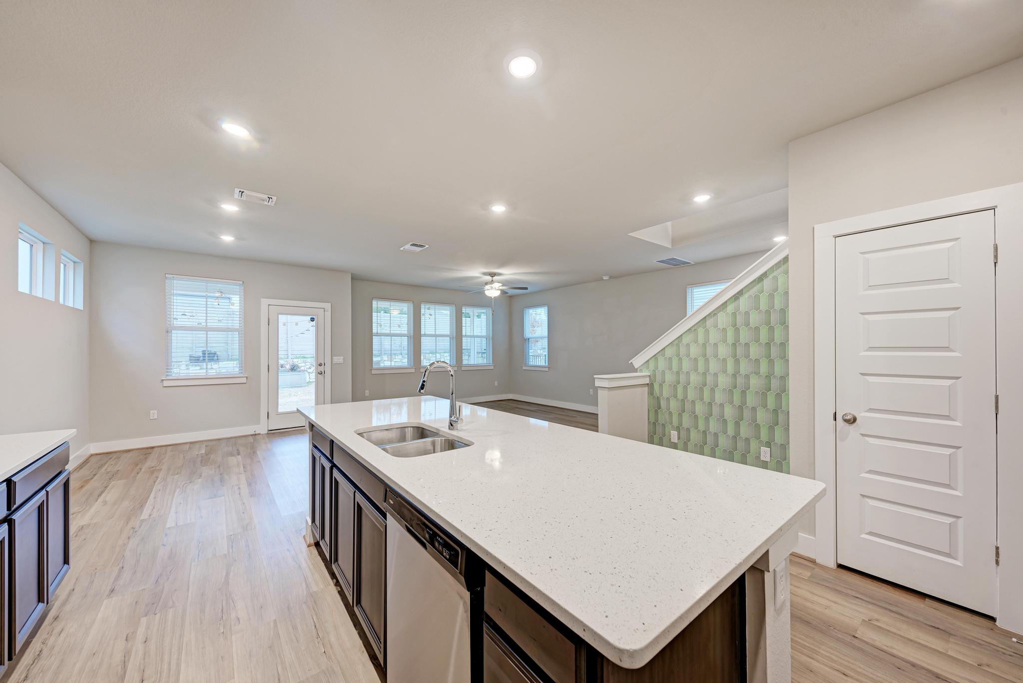 7319 Travertine Spring Drive, Unit 115 Austin, TX 78744 - Photo 37 of 37 a kitchen with a sink a counter space and wooden floor