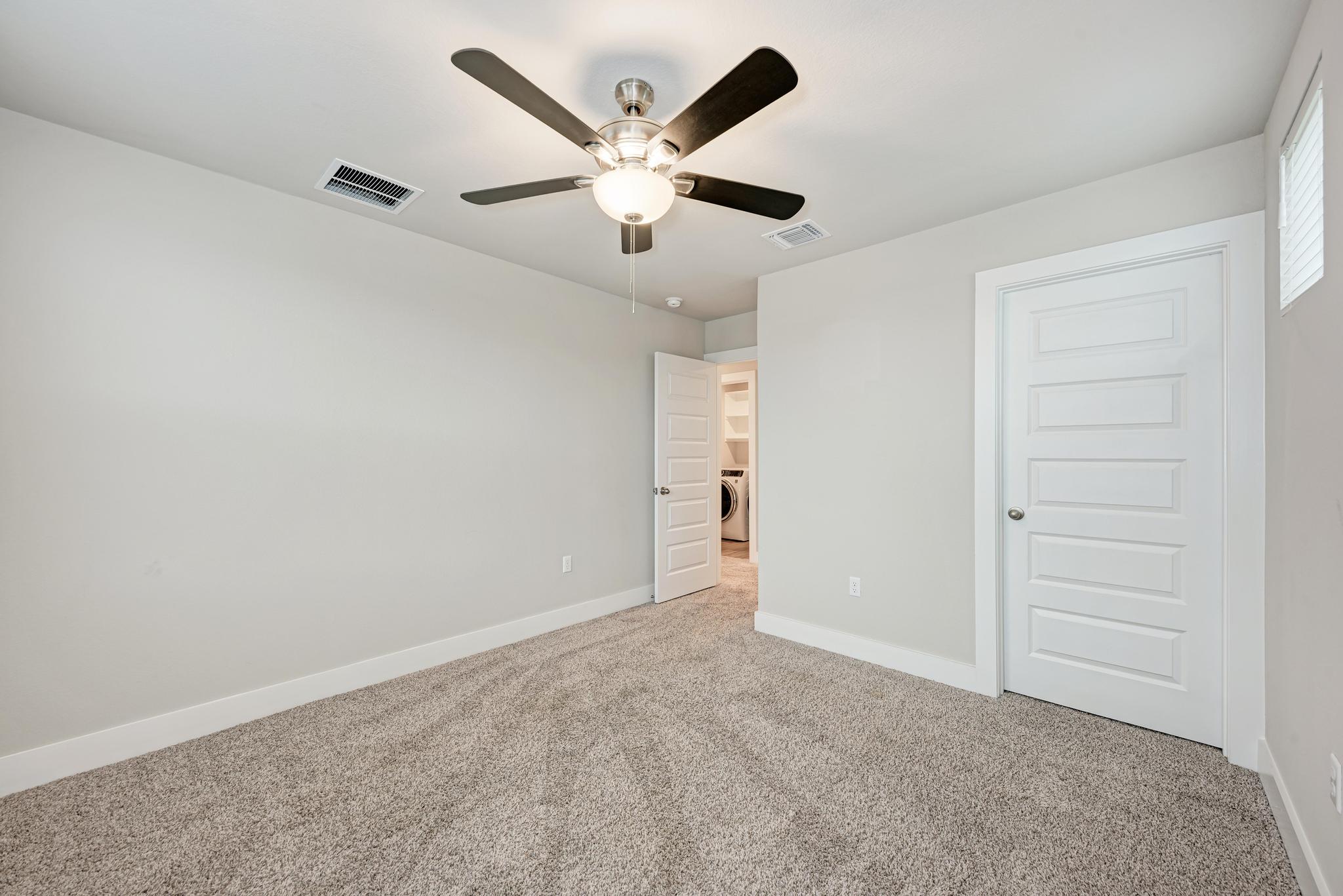 7319 Travertine Spring Drive, Unit 115 Austin, TX 78744 - Photo 28 of 37 an empty room with closet and windows