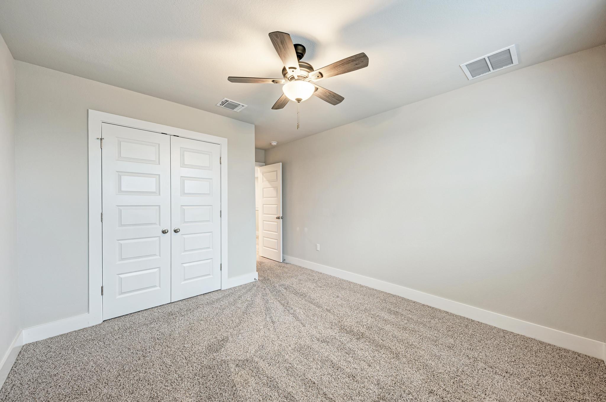 7319 Travertine Spring Drive, Unit 115 Austin, TX 78744 - Photo 31 of 37 an empty room with closet and fan