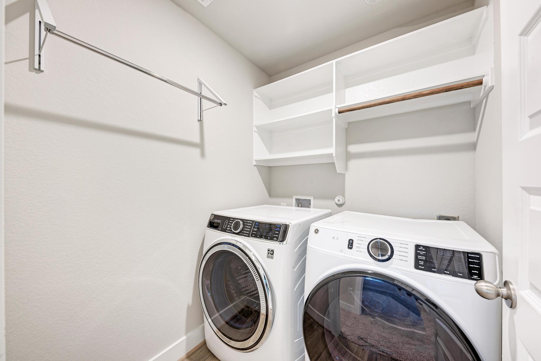 7319 Travertine Spring Drive, Unit 115 Austin, TX 78744 - Photo 32 of 37 a utility room with dryer and washer