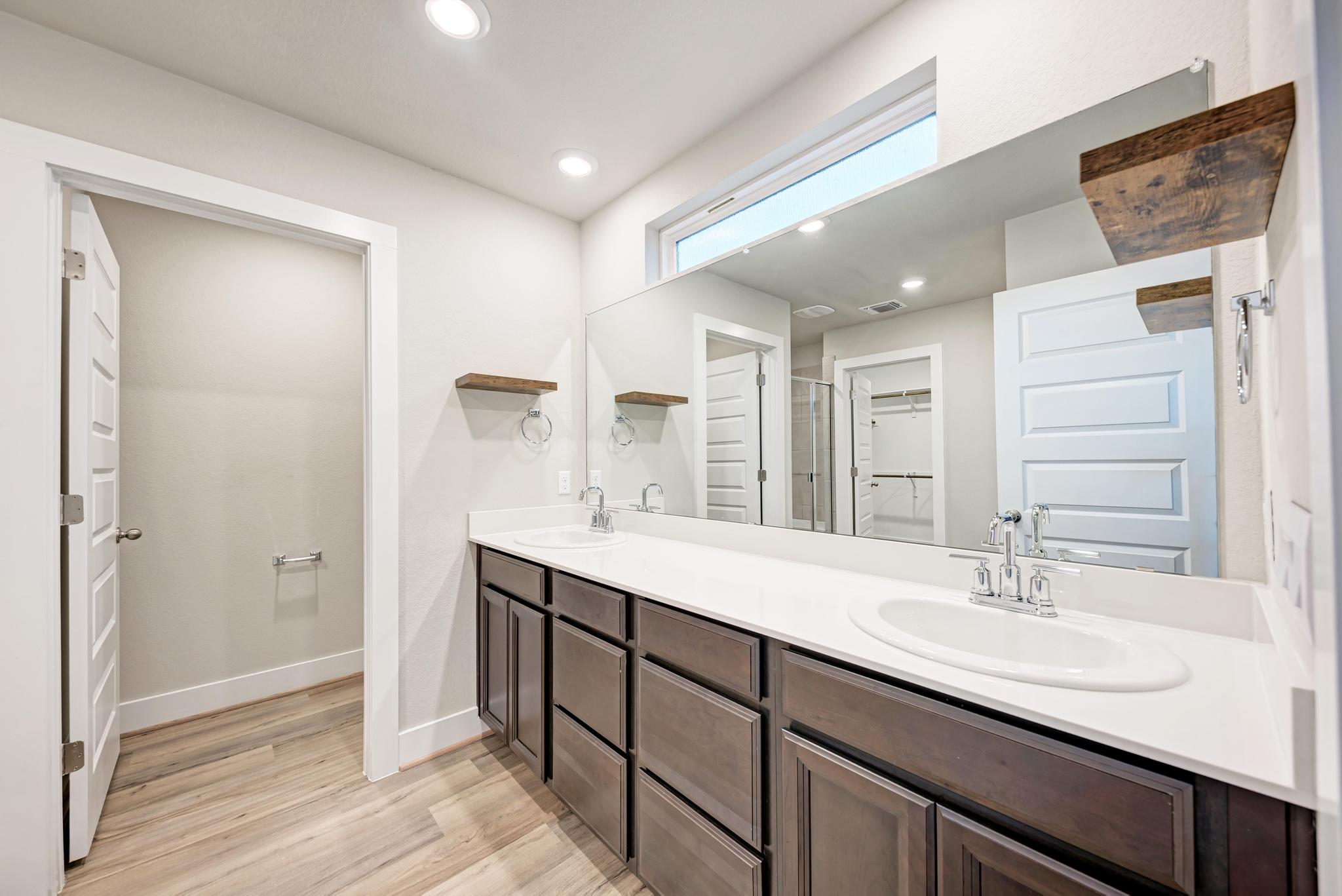 7319 Travertine Spring Drive, Unit 115 Austin, TX 78744 - Photo 5 of 37 a bathroom with a sink double vanity and a mirror