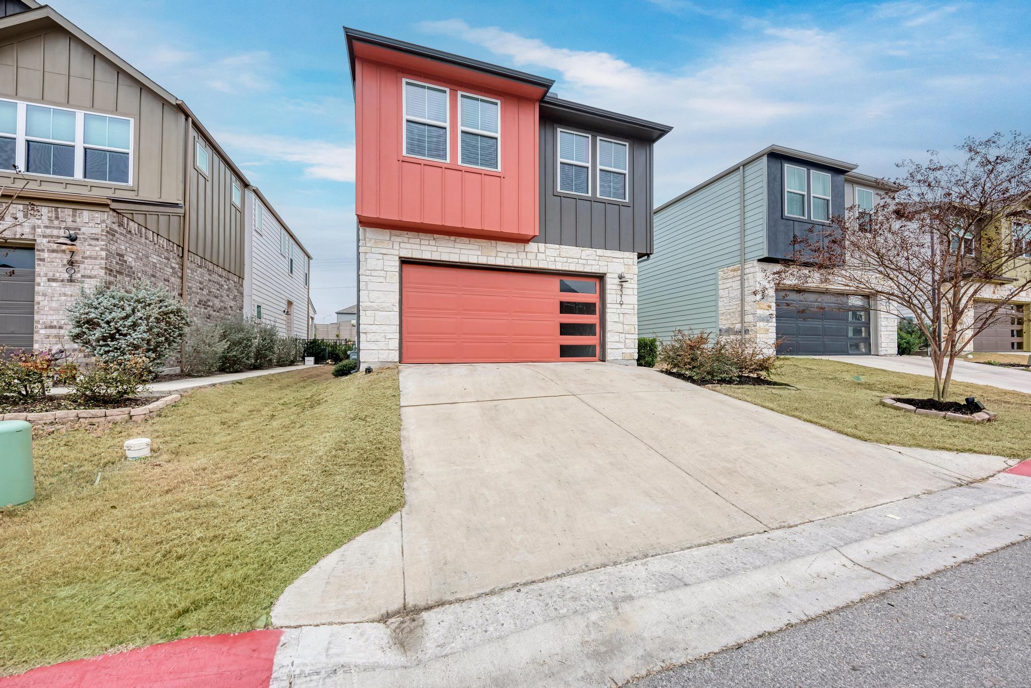 7319 Travertine Spring Drive, Unit 115 Austin, TX 78744 - Photo 10 of 37 a front view of a house with a yard