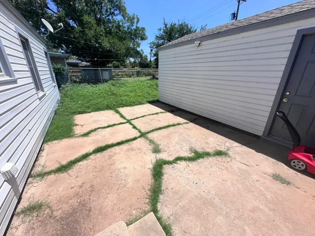 a view of a backyard with sitting area