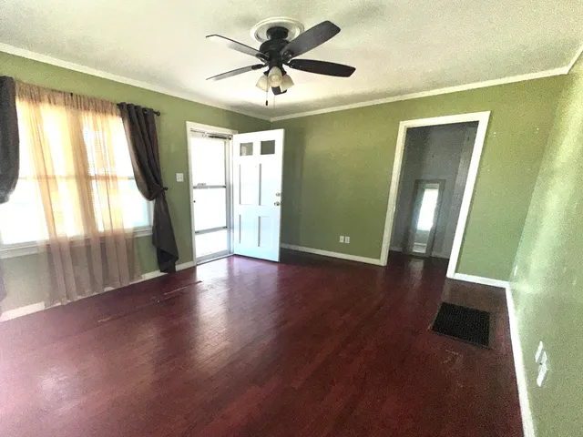 a view of a livingroom with a ceiling fan and window