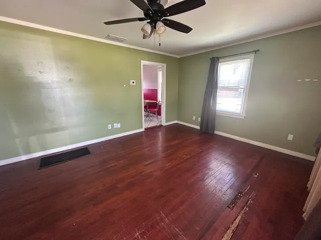 wooden floor in an empty room with a window