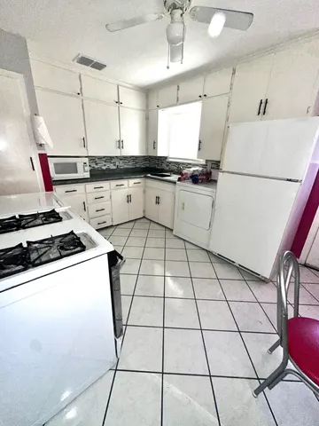 a kitchen with a sink a stove and a refrigerator
