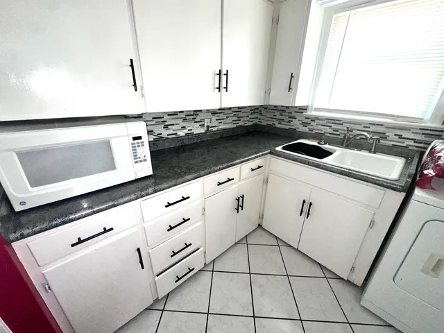 a kitchen with a stove and a microwave