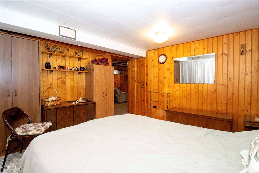 912 Ridgecrest Drive Wooster, OH 44691 - Photo 19 of 27 Carpeted bedroom featuring wooden walls