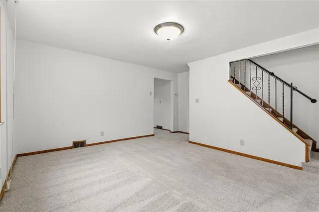 an empty room with closet and windows