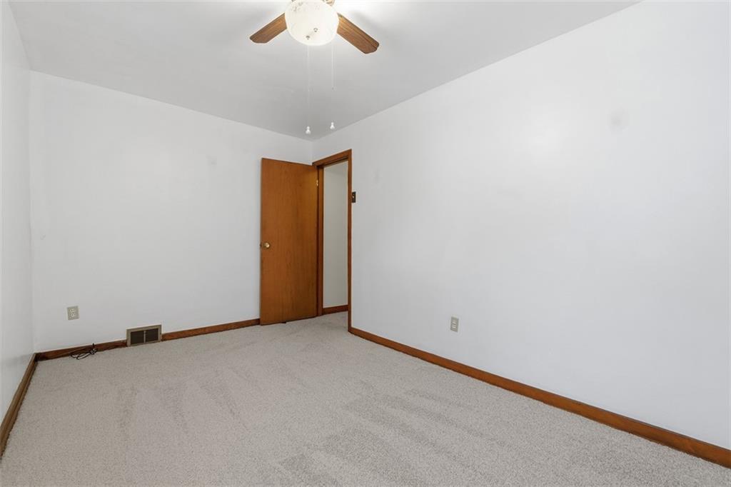 528 9th Street Pitcairn, PA 15140 - Photo 26 of 38 an empty room with a ceiling fan and a window