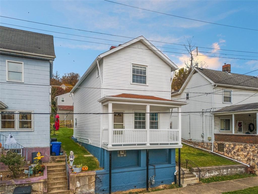 528 9th Street Pitcairn, PA 15140 - Photo 5 of 38 a view of a white house with large windows and a table