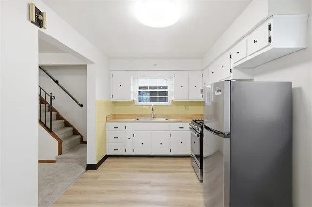 a kitchen with a refrigerator stove and cabinets