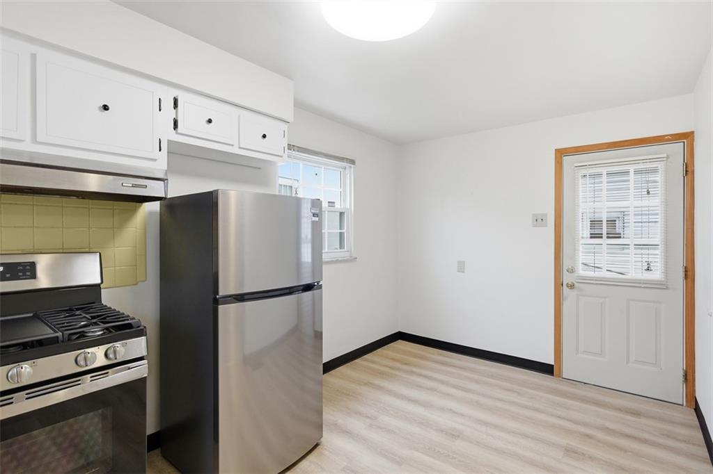 528 9th Street Pitcairn, PA 15140 - Photo 8 of 38 a kitchen with a refrigerator stove and cabinets