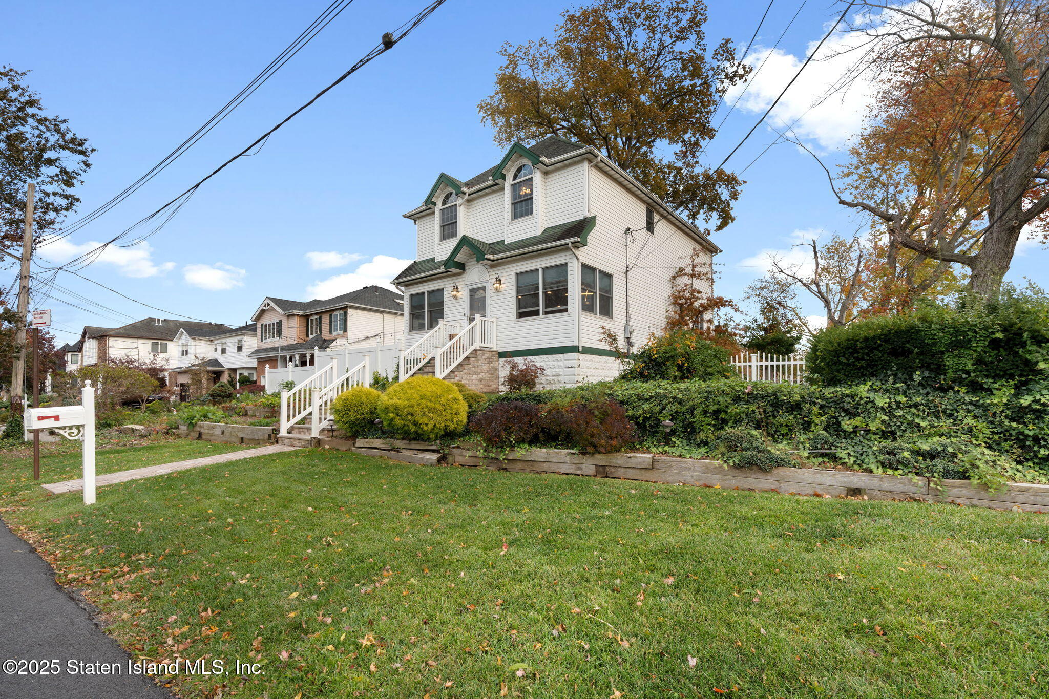a front view of a house with a garden and plants