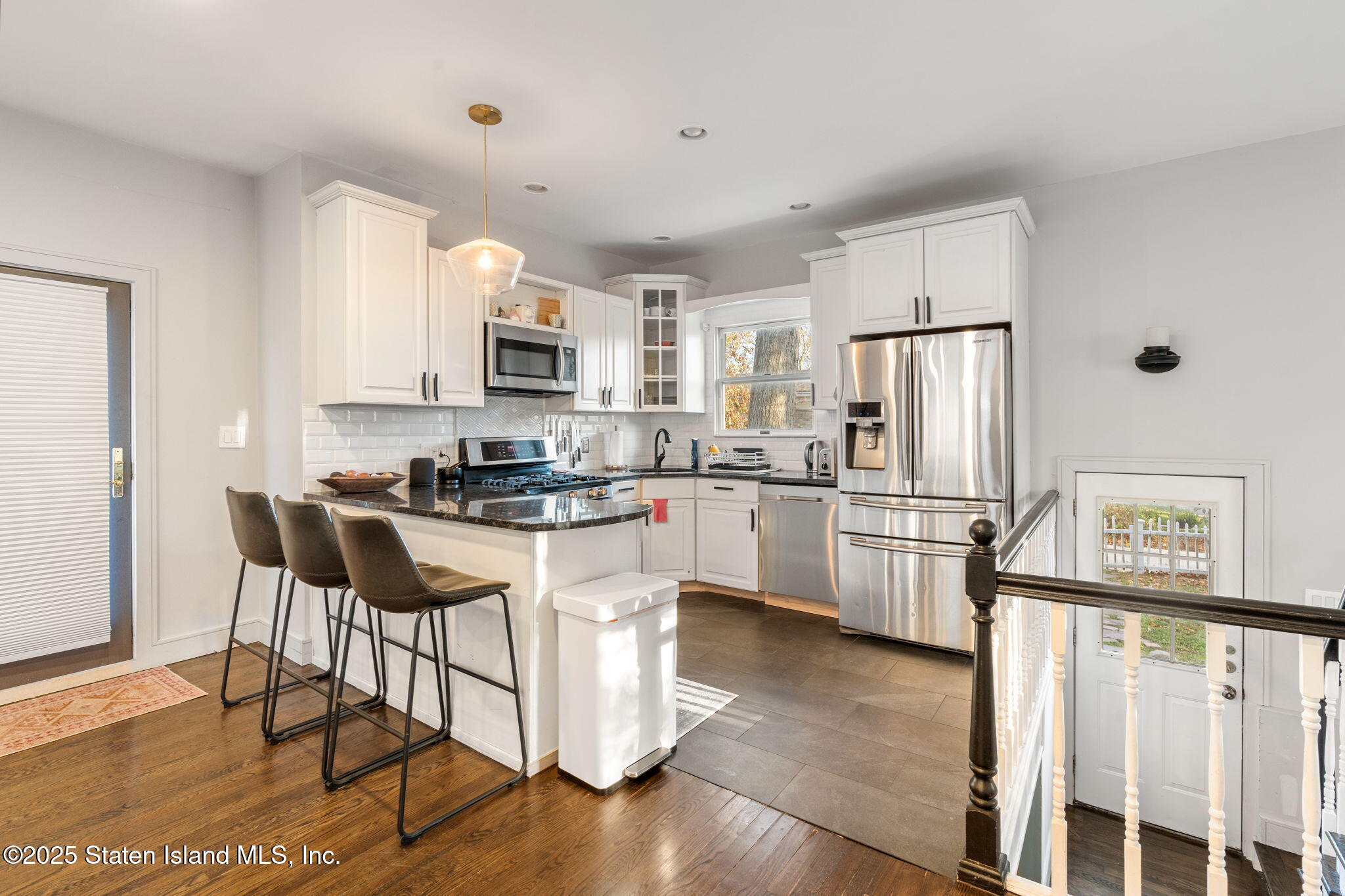 6 Mosely Avenue Staten Island, NY 10312 - Photo 12 of 55 a kitchen with white cabinets and stainless steel appliances