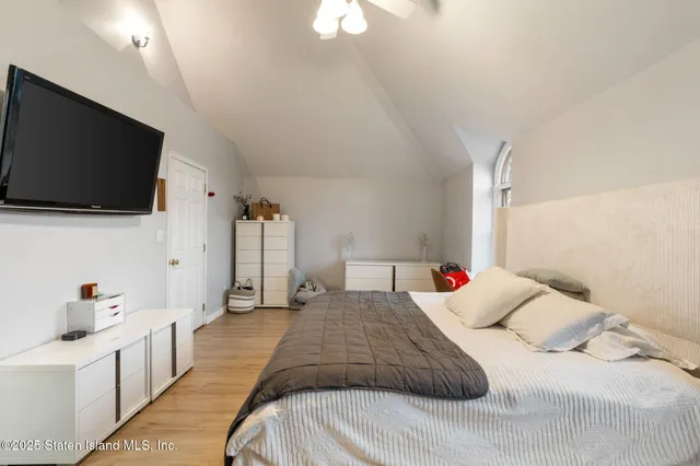 a bedroom with a bed and a flat screen tv