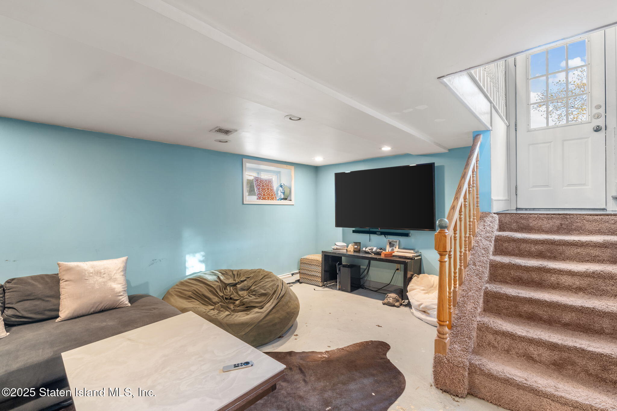 6 Mosely Avenue Staten Island, NY 10312 - Photo 38 of 55 a living room with furniture and a flat screen tv