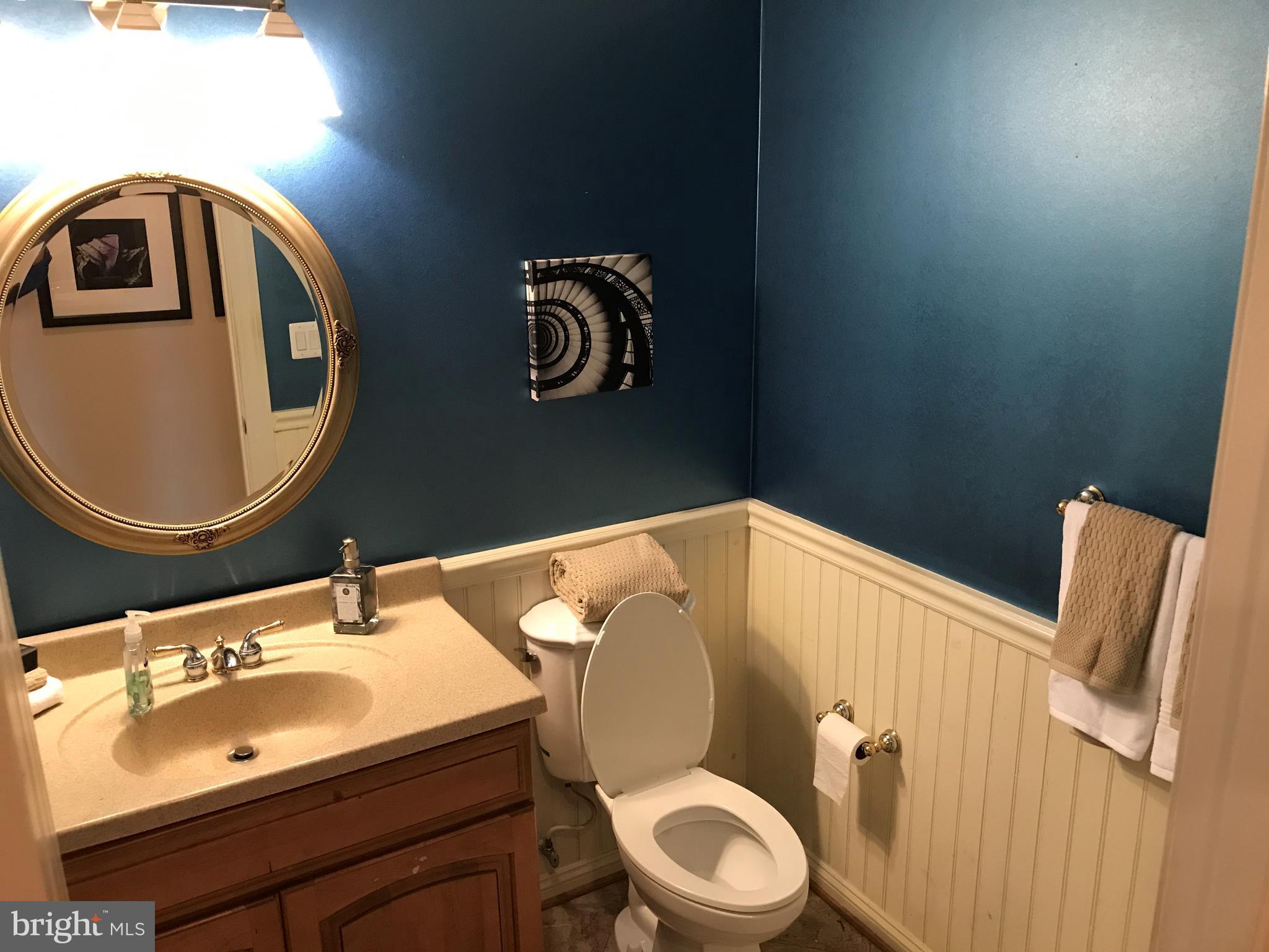 14731 Good Hope Road Silver Spring, MD 20905 - Photo 16 of 30 a bathroom with a toilet a sink and mirror