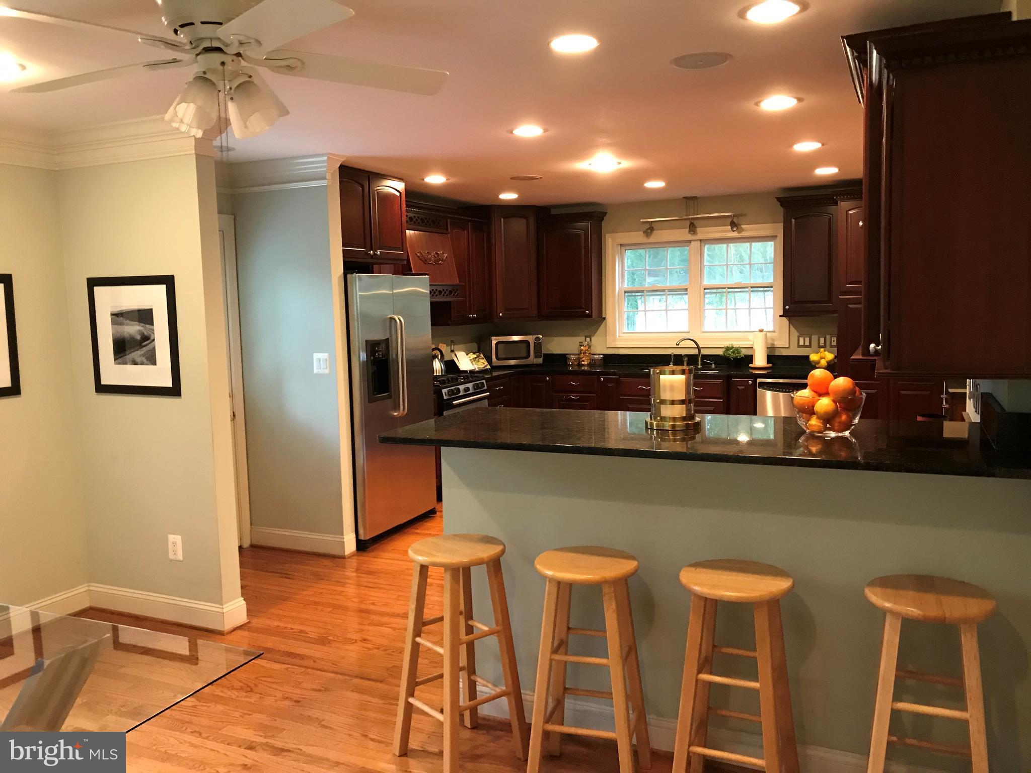 14731 Good Hope Road Silver Spring, MD 20905 - Photo 21 of 30 a kitchen with granite countertop cabinets and chairs