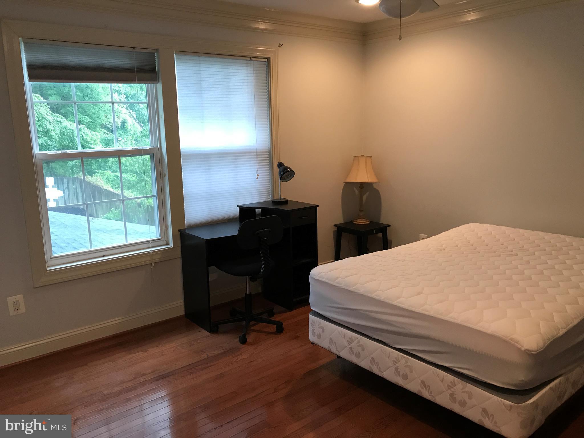 14731 Good Hope Road Silver Spring, MD 20905 - Photo 24 of 30 a bed sitting in a bedroom next to a window