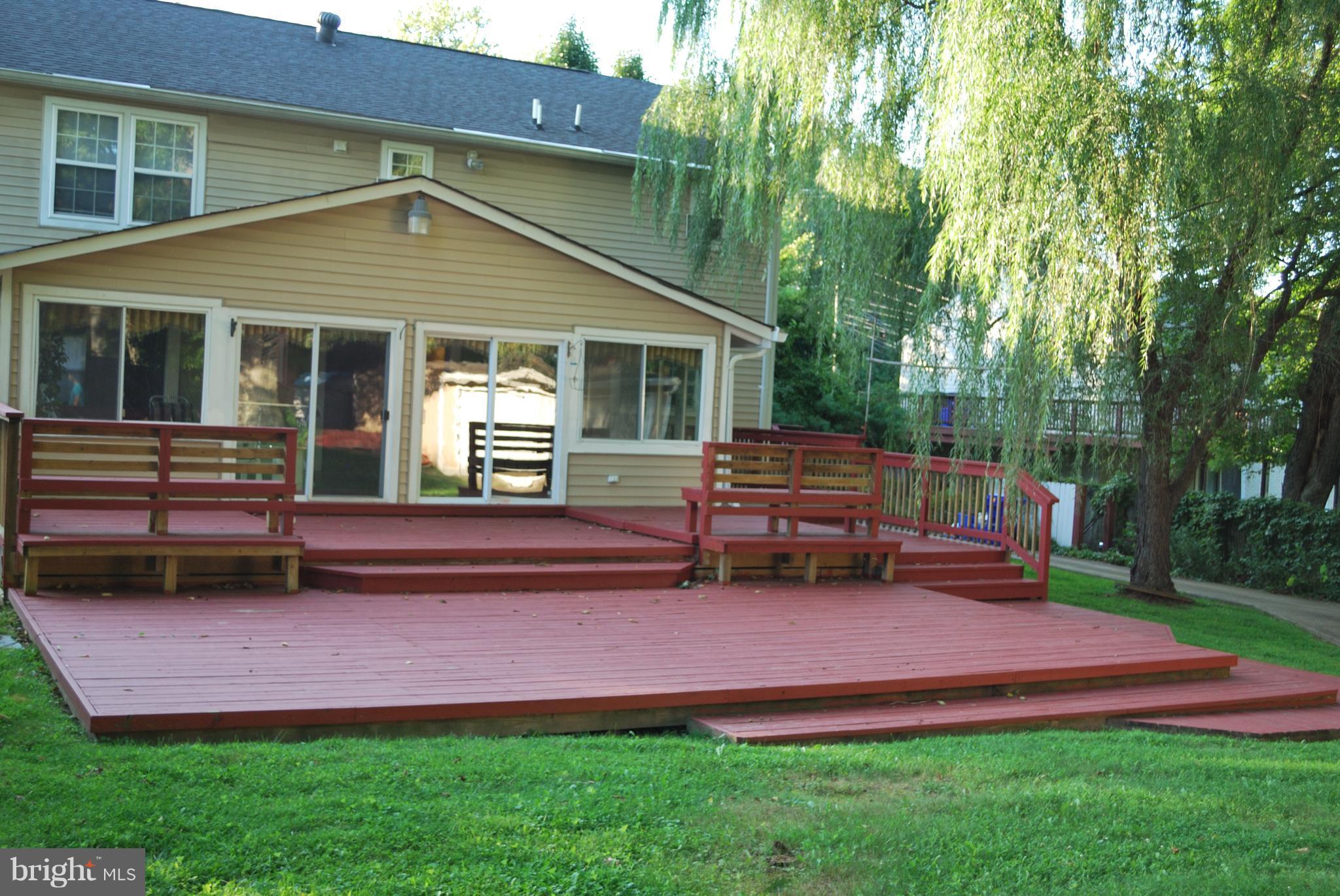 14731 Good Hope Road Silver Spring, MD 20905 - Photo 5 of 30 a backyard of a house with wooden floor bench and couches