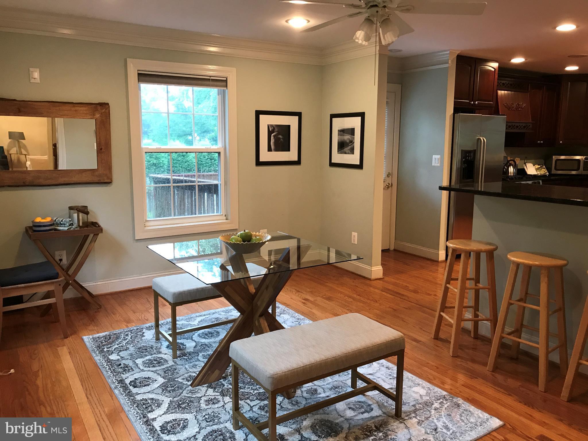 14731 Good Hope Road Silver Spring, MD 20905 - Photo 7 of 30 a workspace with furniture wooden floor and a chandelier