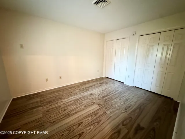 a view of room with wooden floor