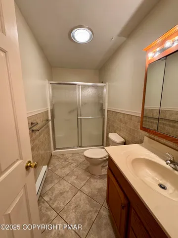 a bathroom with a sink and mirror with toilet