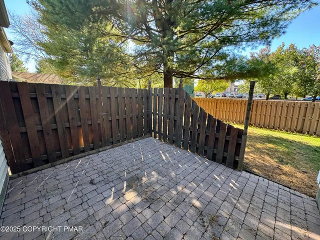 a view of wooden fence and trees