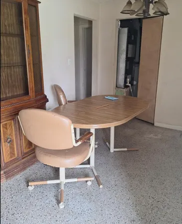 a view of a room that has a table and chair