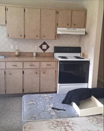a kitchen with stainless steel appliances granite countertop a stove a sink and cabinets