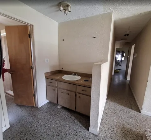 a view of hallway with cabinets