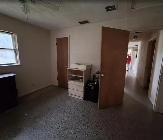 an empty room with furniture and windows