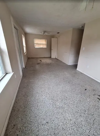 a view of an empty room with windows